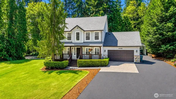 a front view of a house with a yard and garage