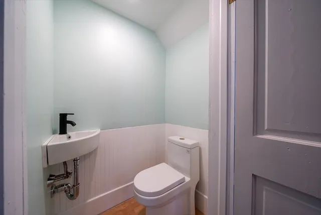 a white toilet sitting next to a bathroom sink