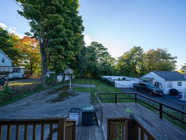 a view of a wooden deck and a yard