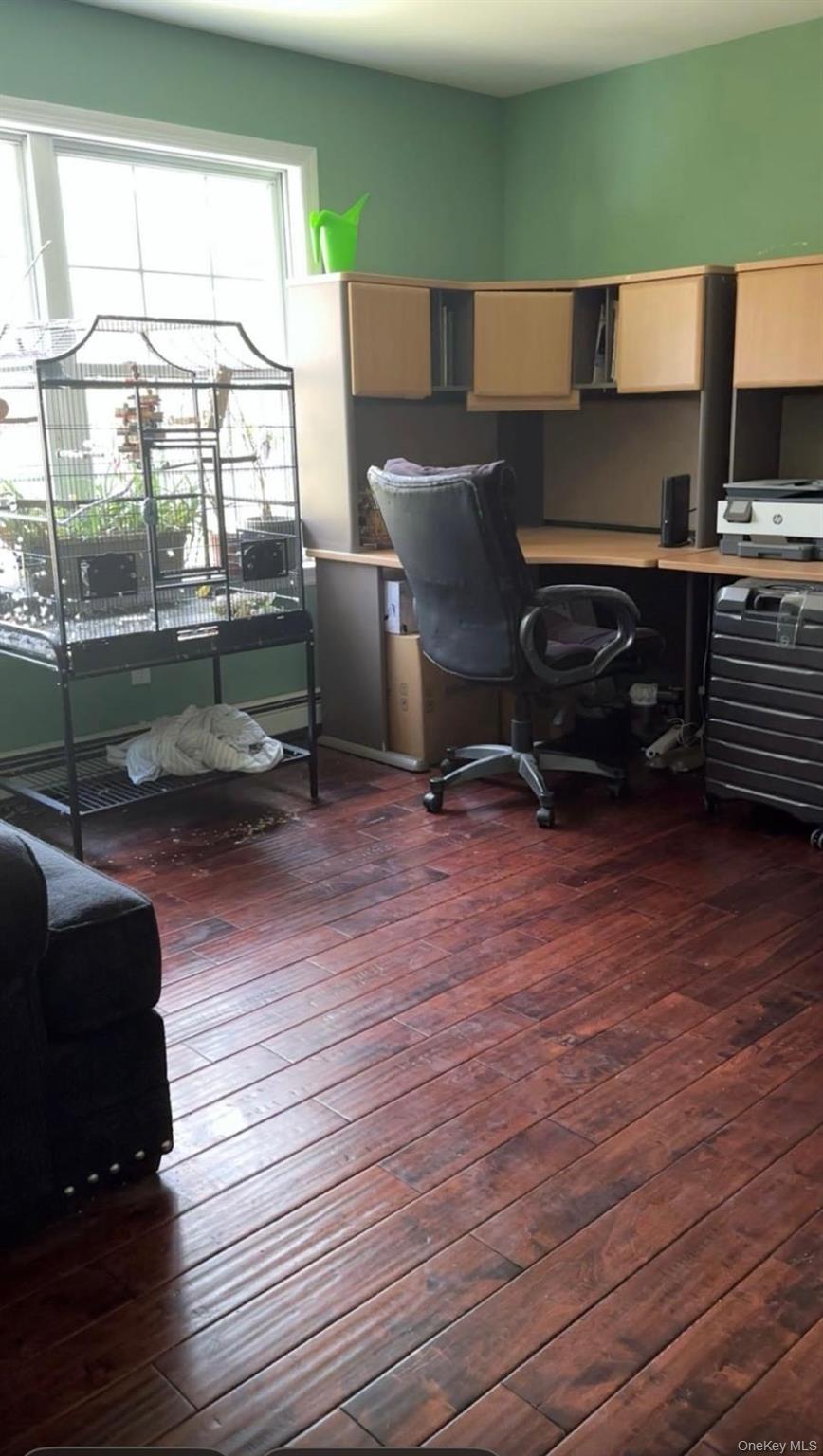 43 North Cozine Road Manorville, NY 11949 - Photo 25 of 42 a living room with a balcony wooden floor and furniture