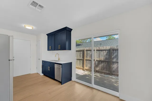 a view of a room with wooden floor and sliding glass door