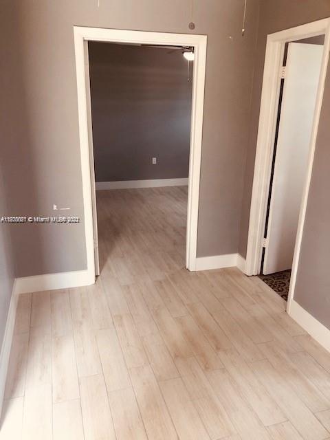 11241 Southwest 7th Terrace, Unit 1 Sweetwater, FL 33174 - Photo 8 of 34 an empty room with wooden floor and entrance