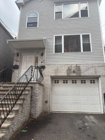a front view of a house with wooden stairs