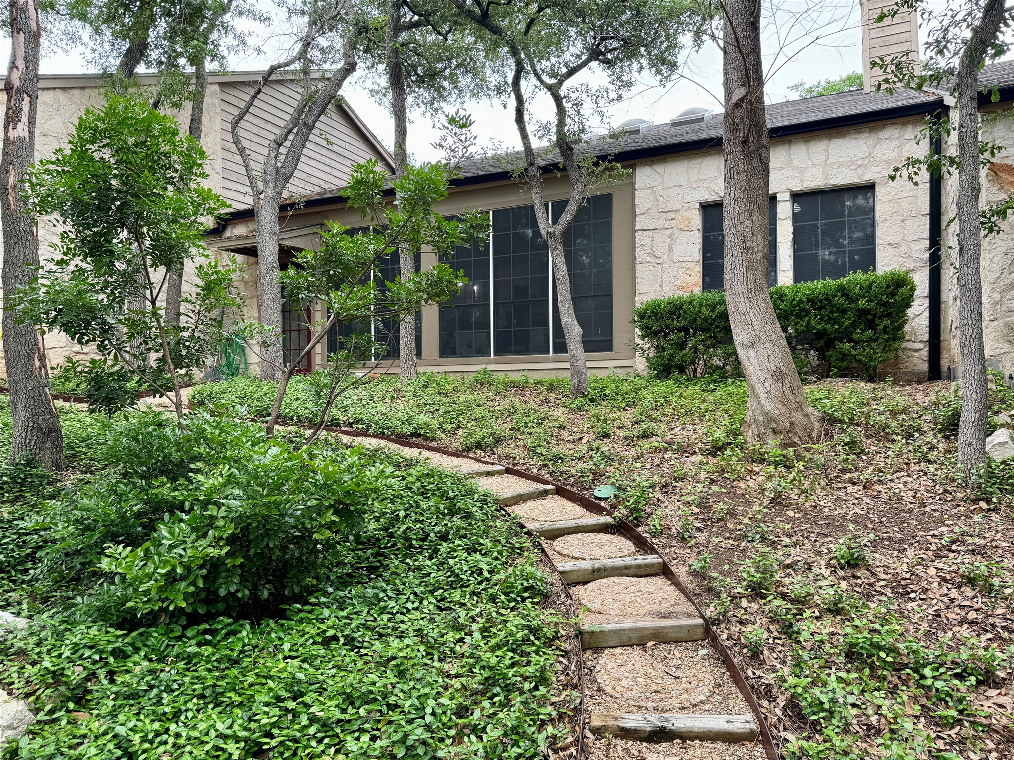3809 Spicewood Springs Road, Unit 137 Austin, TX 78759 - Photo 32 of 34 a front view of a house with garden