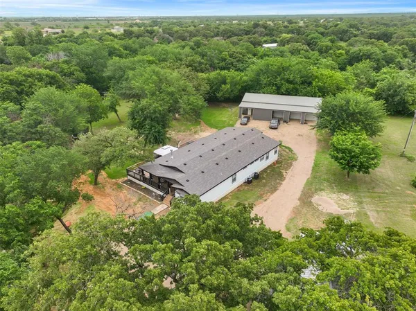 an aerial view of a house with a yard
