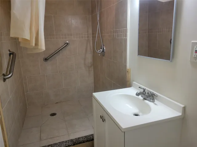 a bathroom with a sink a shower and a mirror