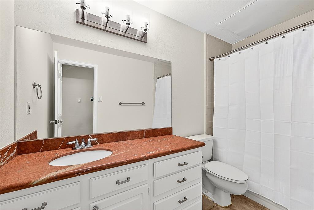 5407 Bryan Street, Unit B104 Dallas, TX 75206 - Photo 15 of 38 a bathroom with a granite countertop sink and a mirror