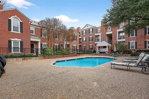 a view of a building with swimming pool and sitting area