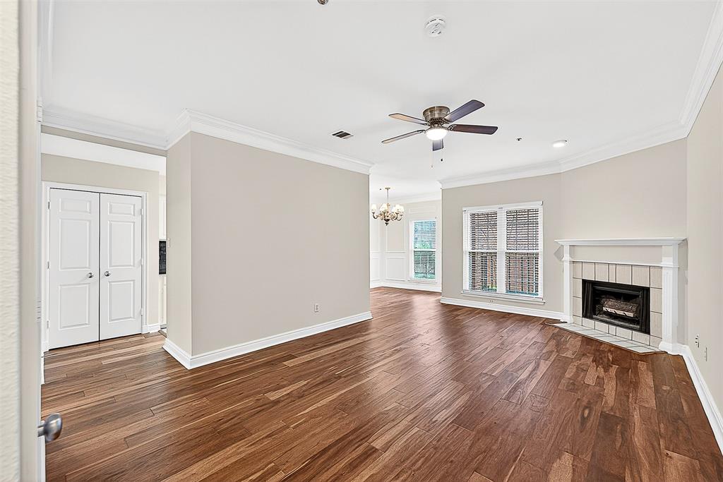 5407 Bryan Street, Unit B104 Dallas, TX 75206 - Photo 29 of 38 a view of an empty room with wooden floor fireplace and a window