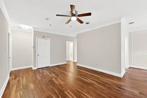 an empty room with fan and a fireplace