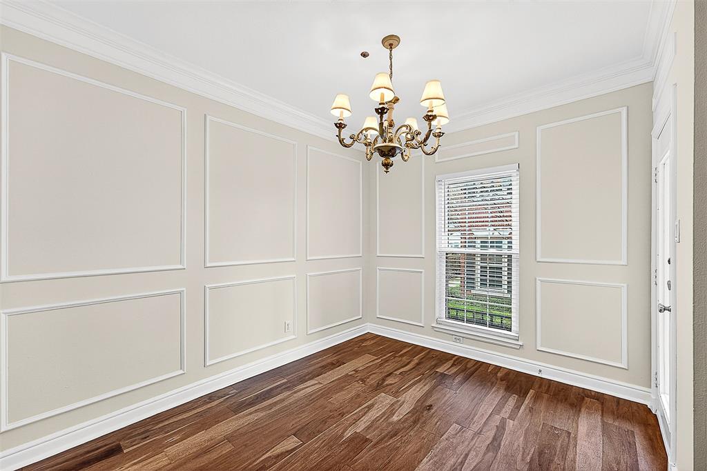 5407 Bryan Street, Unit B104 Dallas, TX 75206 - Photo 34 of 38 a view of an empty room with wooden floor and a window
