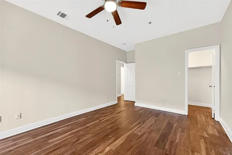a view of a room with wooden floor and windows