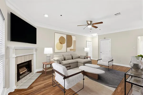 a living room with furniture a fireplace and a flat screen tv