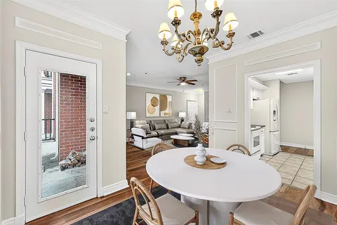 a view of a dining room with furniture wooden floor and chandelier