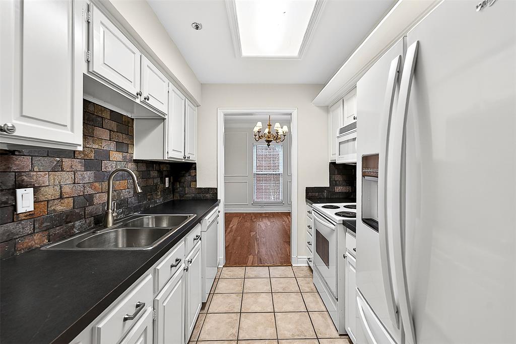 5407 Bryan Street, Unit B104 Dallas, TX 75206 - Photo 9 of 38 a kitchen with stainless steel appliances granite countertop a sink stove and refrigerator
