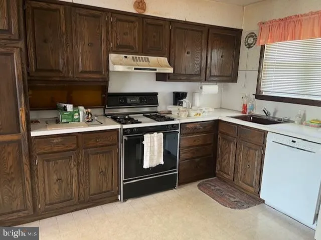a kitchen with a sink stove and microwave
