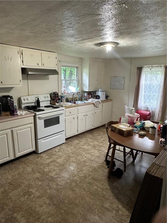 113 Morton Avenue Butler, PA 16001 - Photo 6 of 15 a kitchen with a white cabinets and chairs