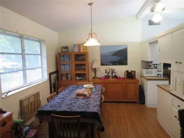 a kitchen with stainless steel appliances granite countertop a stove refrigerator and a wooden floors