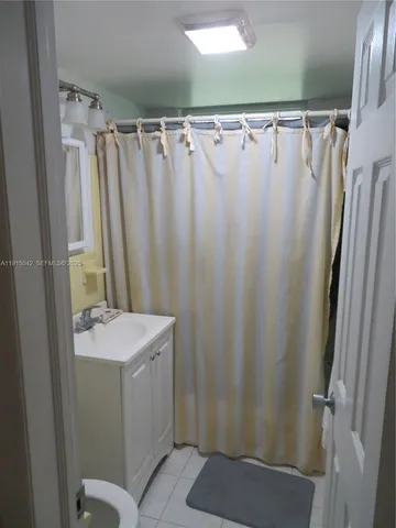 a bathroom with sink a mirror a shower and vanity