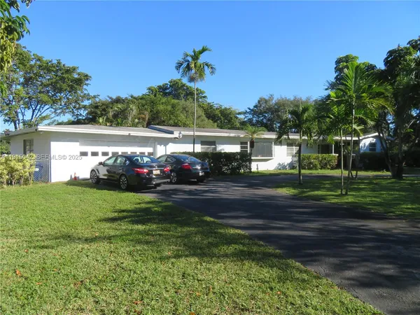 a front view of a house with a garden