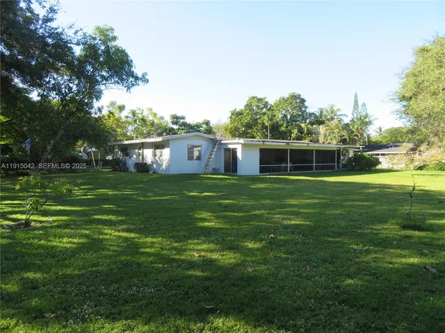 a house view with swimming pool in front of it