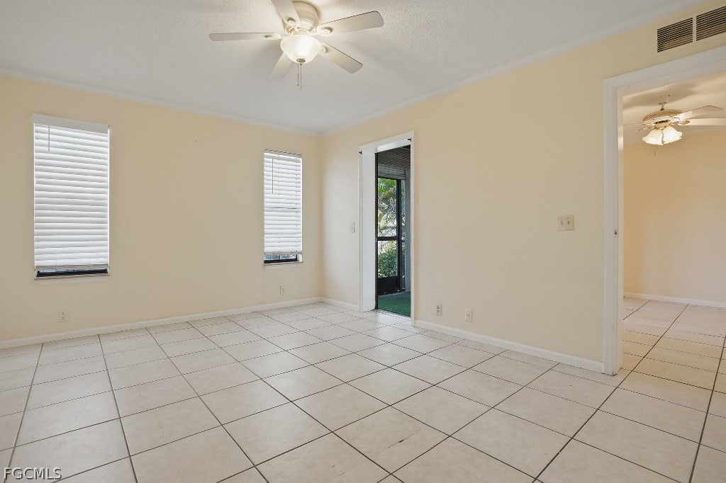 5369 Treetops Drive, Unit M102 Naples, FL 34113 - Photo 7 of 11 an empty room with windows and fan