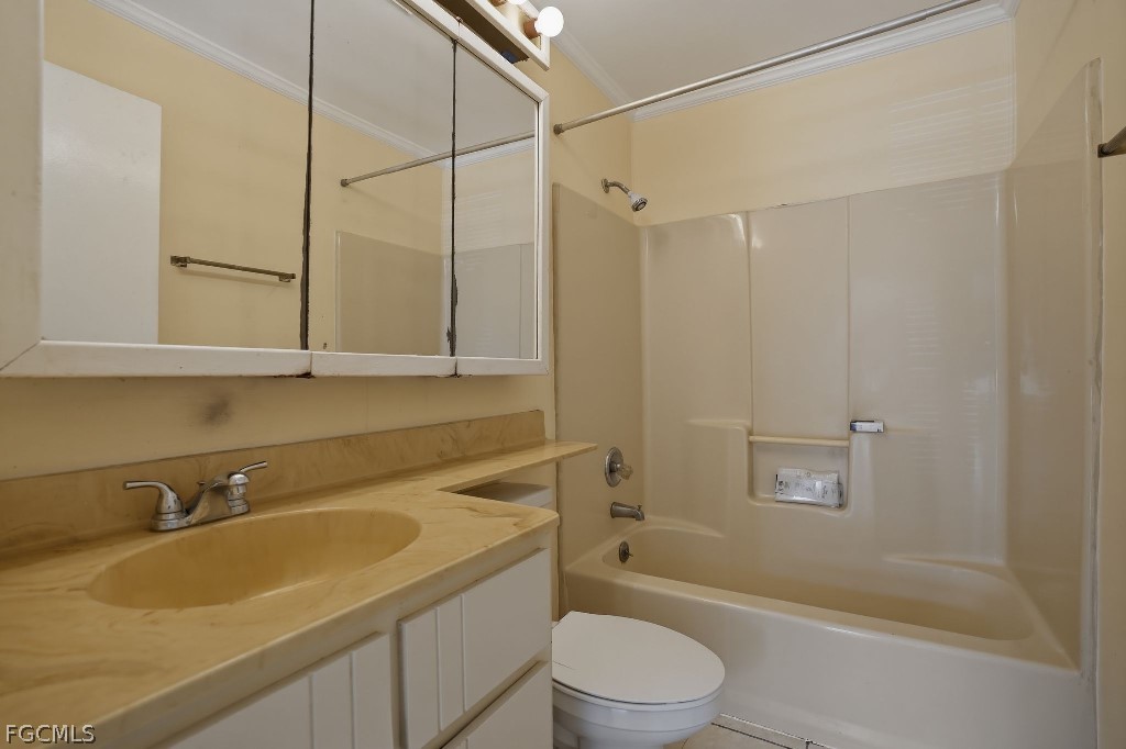 5369 Treetops Drive, Unit M102 Naples, FL 34113 - Photo 8 of 11 a bathroom with a sink a toilet and shower