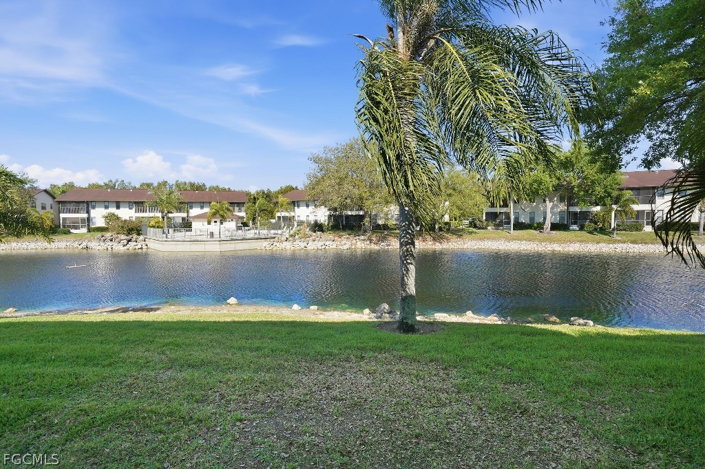 5369 Treetops Drive, Unit M102 Naples, FL 34113 - Photo 10 of 11 a view of a lake with houses in the background