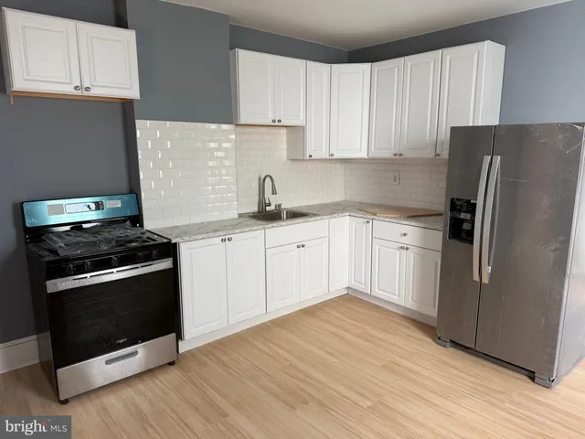 a kitchen with a sink stove and refrigerator
