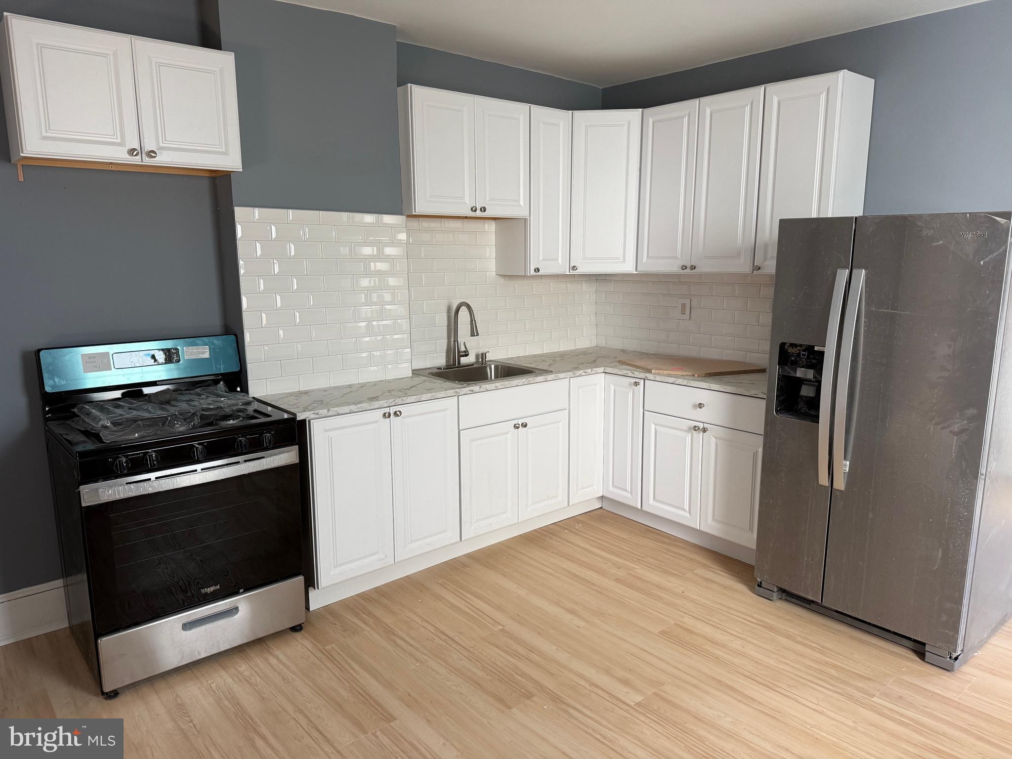 504 Taylor Street Riverside, NJ 08075 - Photo 2 of 11 a kitchen with a sink stove and refrigerator