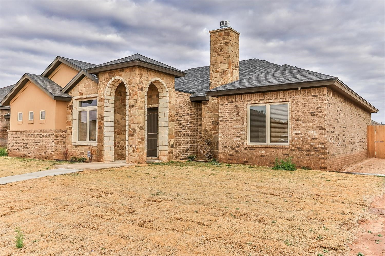 5234 Kemper Street Lubbock, TX 79416 - Photo 3 of 10 a front view of a house with a yard
