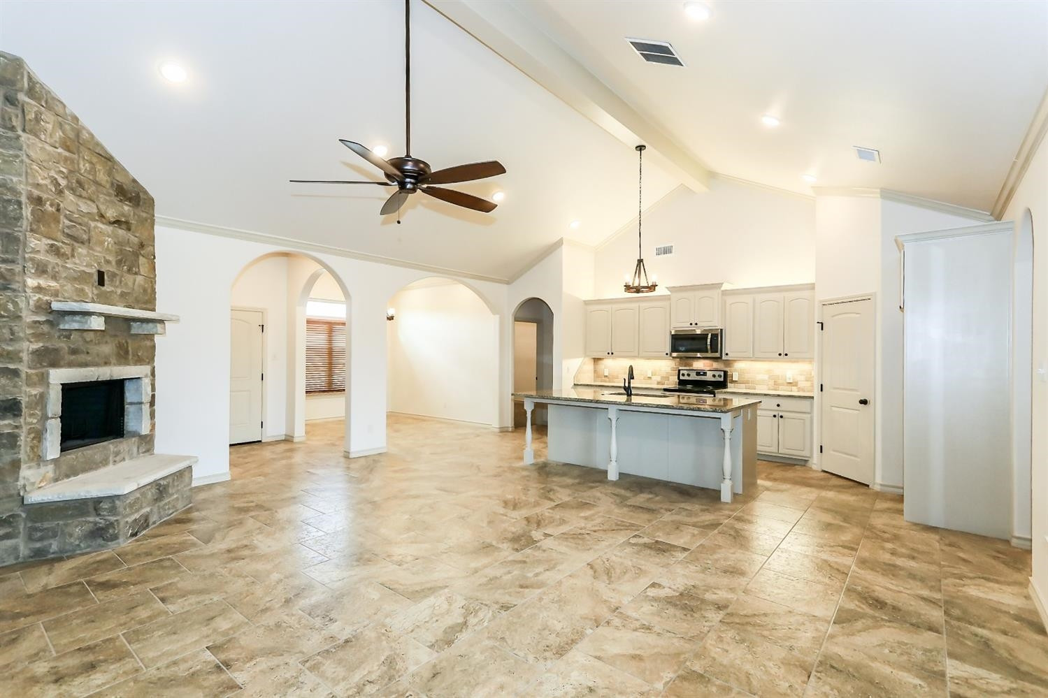 5234 Kemper Street Lubbock, TX 79416 - Photo 7 of 10 a large kitchen with cabinets a sink and stainless steel appliances
