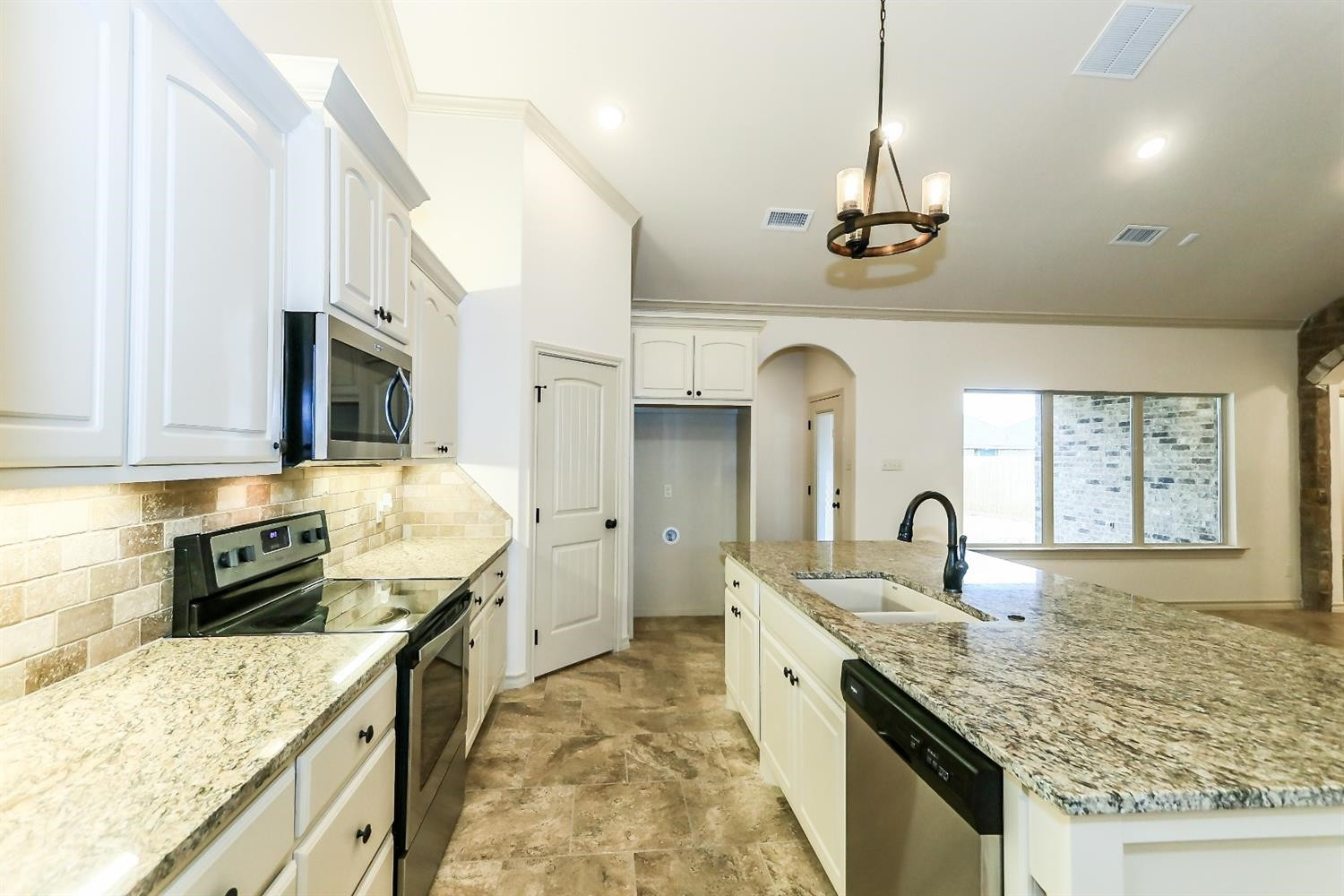 5234 Kemper Street Lubbock, TX 79416 - Photo 10 of 10 a kitchen with stainless steel appliances granite countertop a oven a stove a sink dishwasher and wooden cabinets with wooden floor