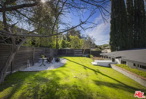 a view of a swimming pool with a patio and plants