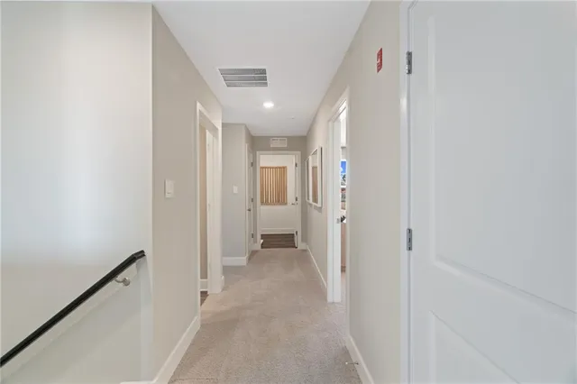 a view of a hallway with wooden shelves