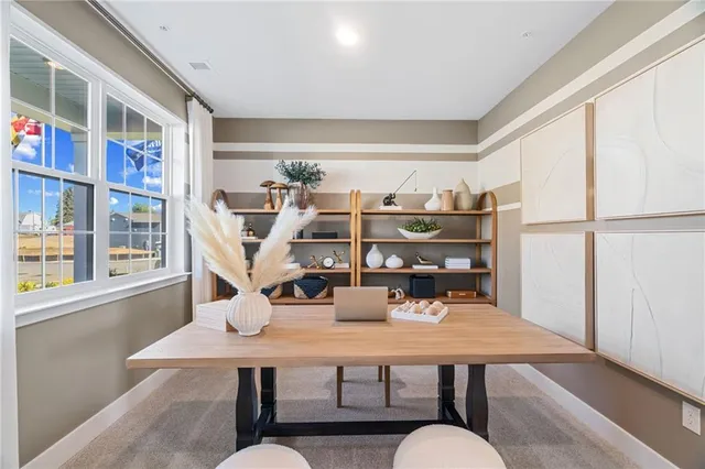 a view of a dining room with furniture and a book shelf