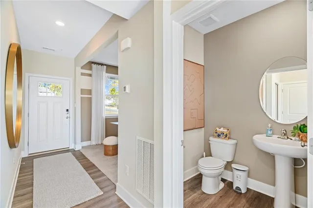 a bathroom with a toilet sink and shower