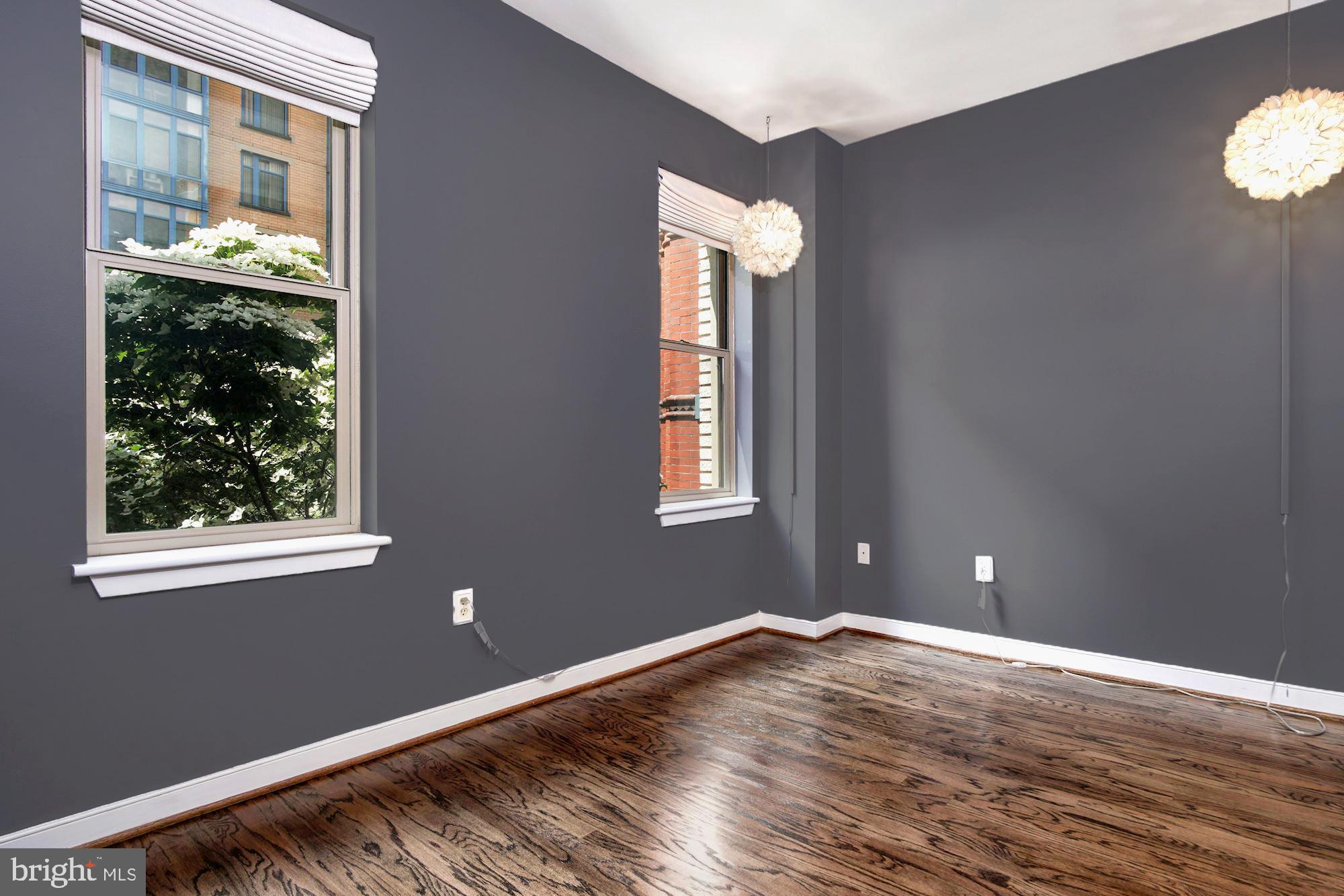 1445 N Street Northwest, Unit 202 Washington, DC 20005 - Photo 11 of 23 a view of empty room with wooden floor and fan
