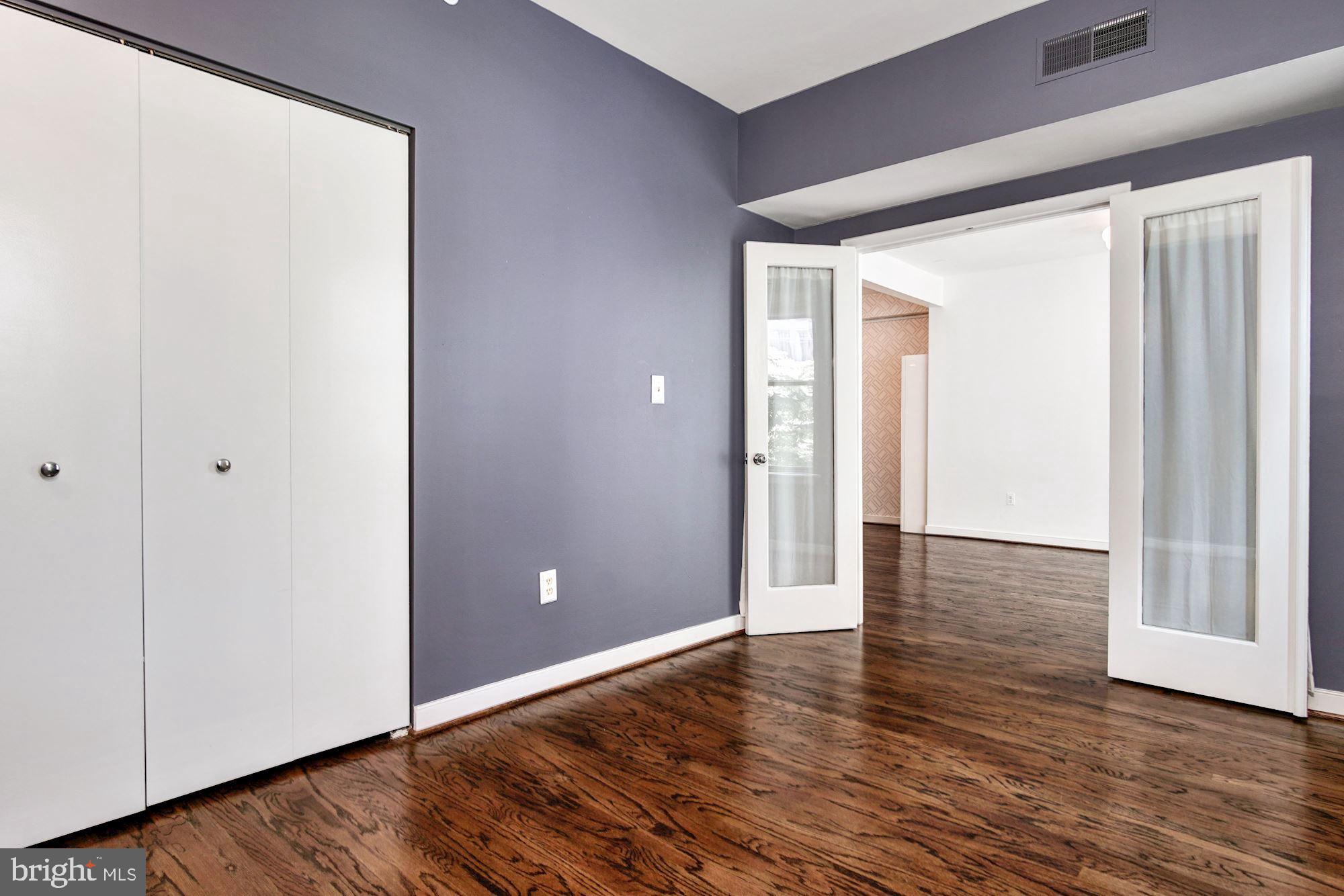 1445 N Street Northwest, Unit 202 Washington, DC 20005 - Photo 12 of 23 a view of an empty room with wooden floor