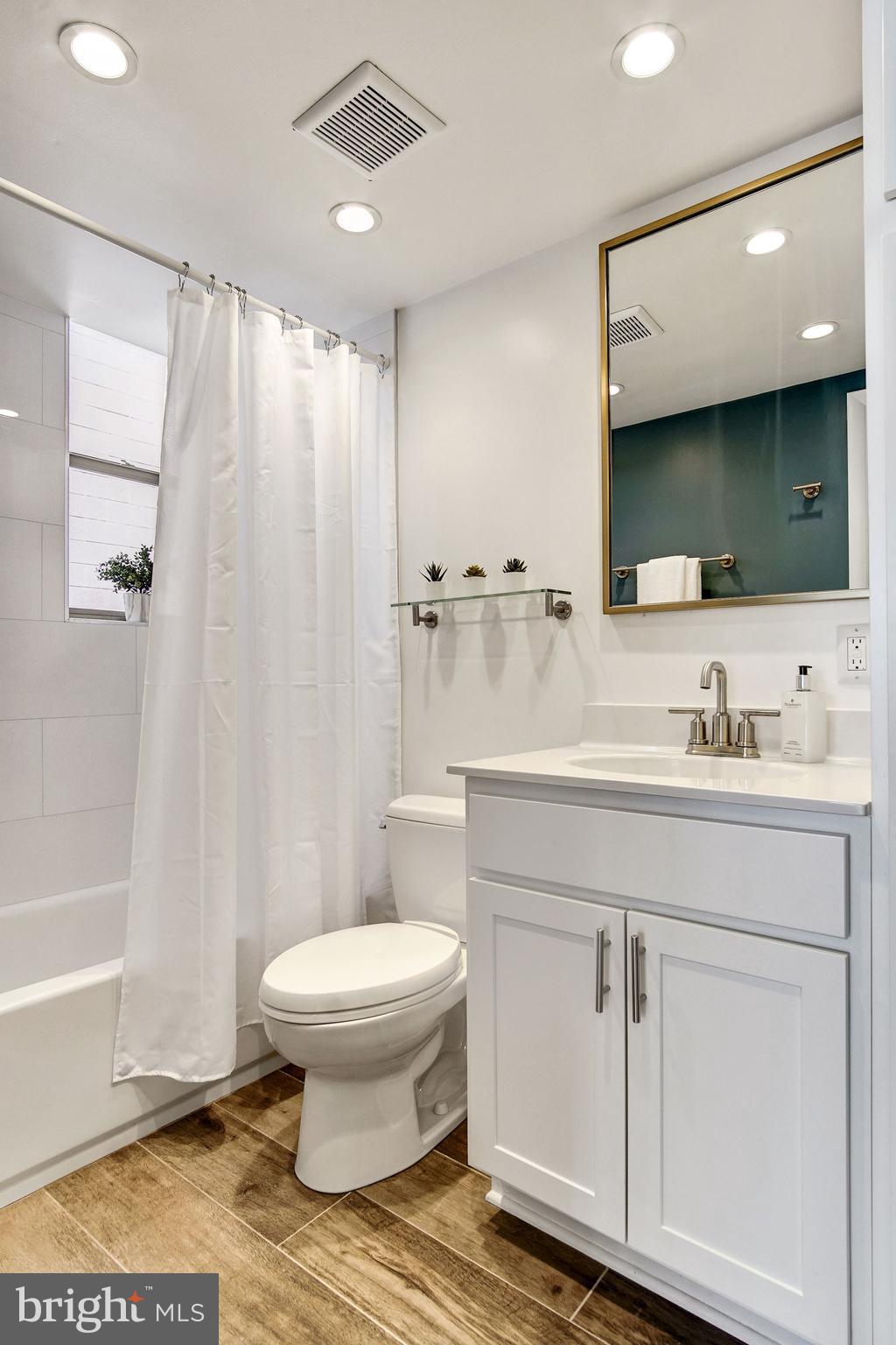 1445 N Street Northwest, Unit 202 Washington, DC 20005 - Photo 13 of 23 a bathroom with a sink toilet and shower