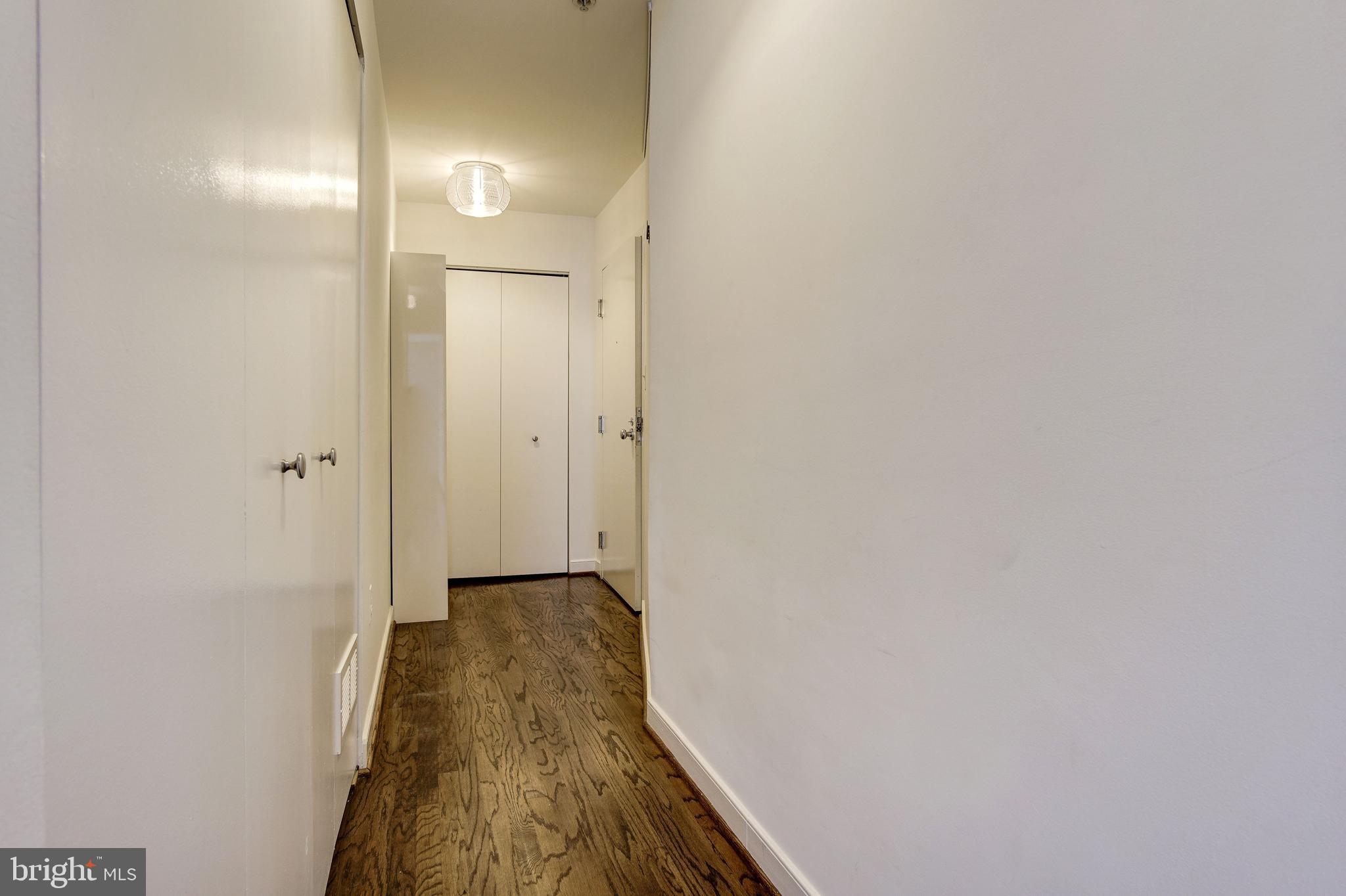 1445 N Street Northwest, Unit 202 Washington, DC 20005 - Photo 16 of 23 a view of a hallway with wooden floor