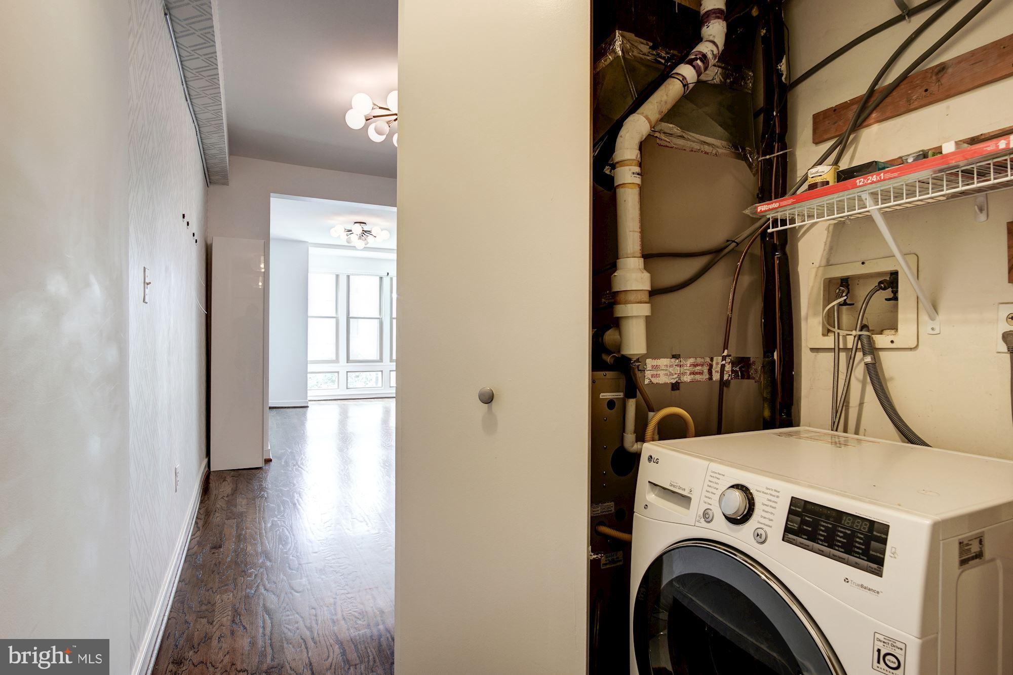 1445 N Street Northwest, Unit 202 Washington, DC 20005 - Photo 17 of 23 a view of storage and utility room with washer and dryer