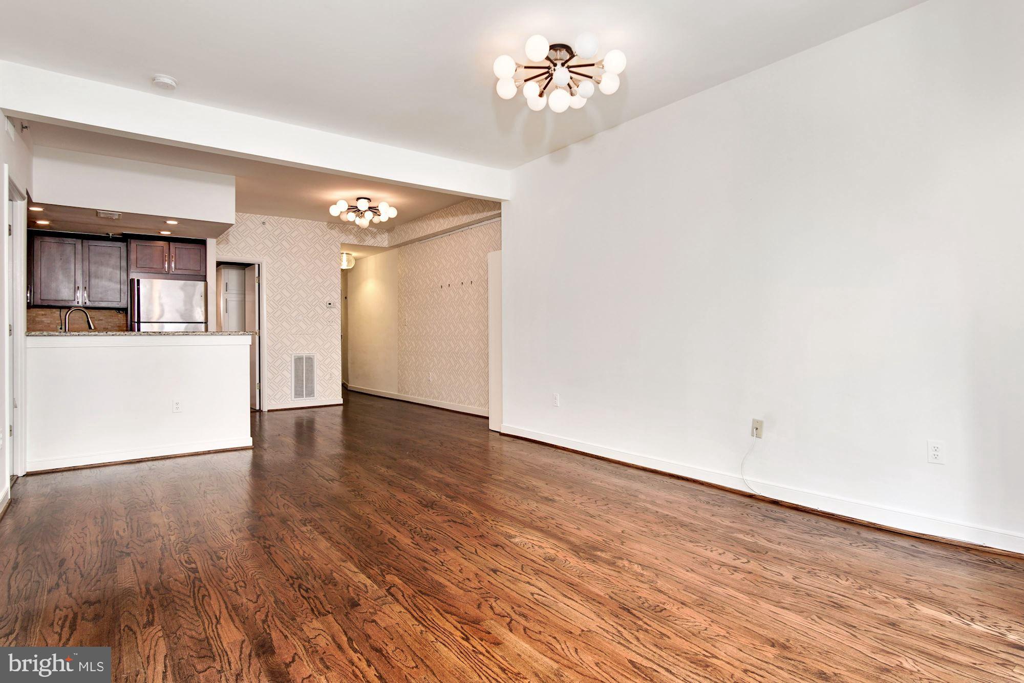 1445 N Street Northwest, Unit 202 Washington, DC 20005 - Photo 7 of 23 a view of an empty room with wooden floor