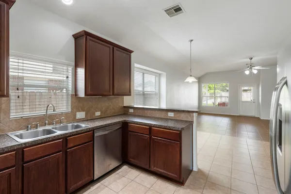 a kitchen with a sink stove and cabinets