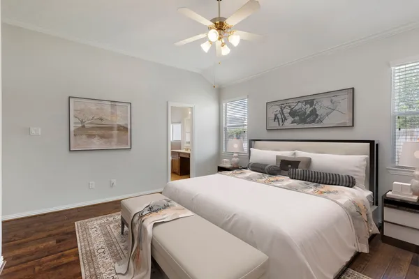 a bedroom with a large bed and a chandelier