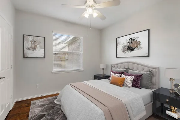 a bedroom with a bed and a painting on the wall