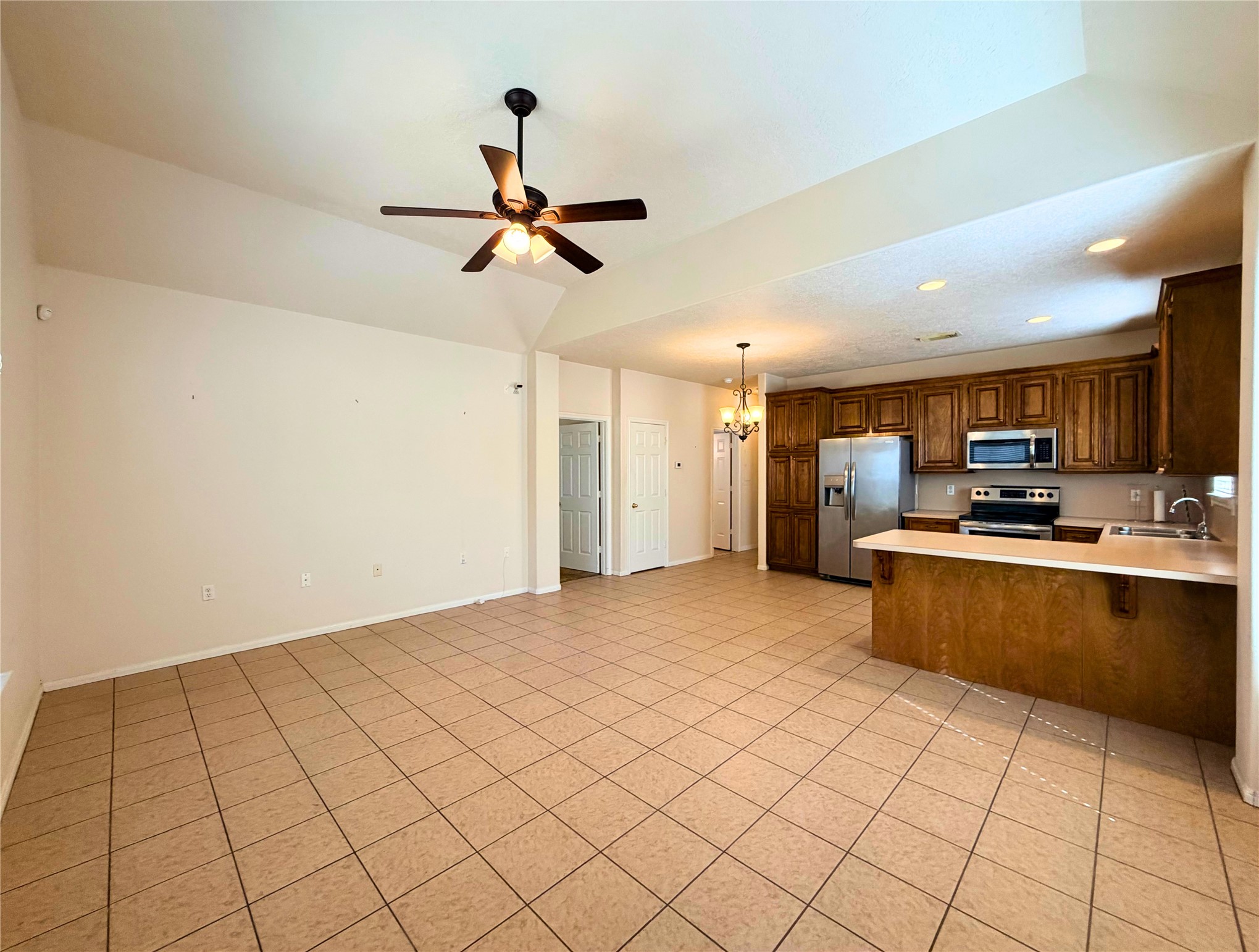 312 Hunt Road, Unit 312 Baytown, TX 77521 - Photo 11 of 28 a kitchen with stainless steel appliances a refrigerator and microwave
