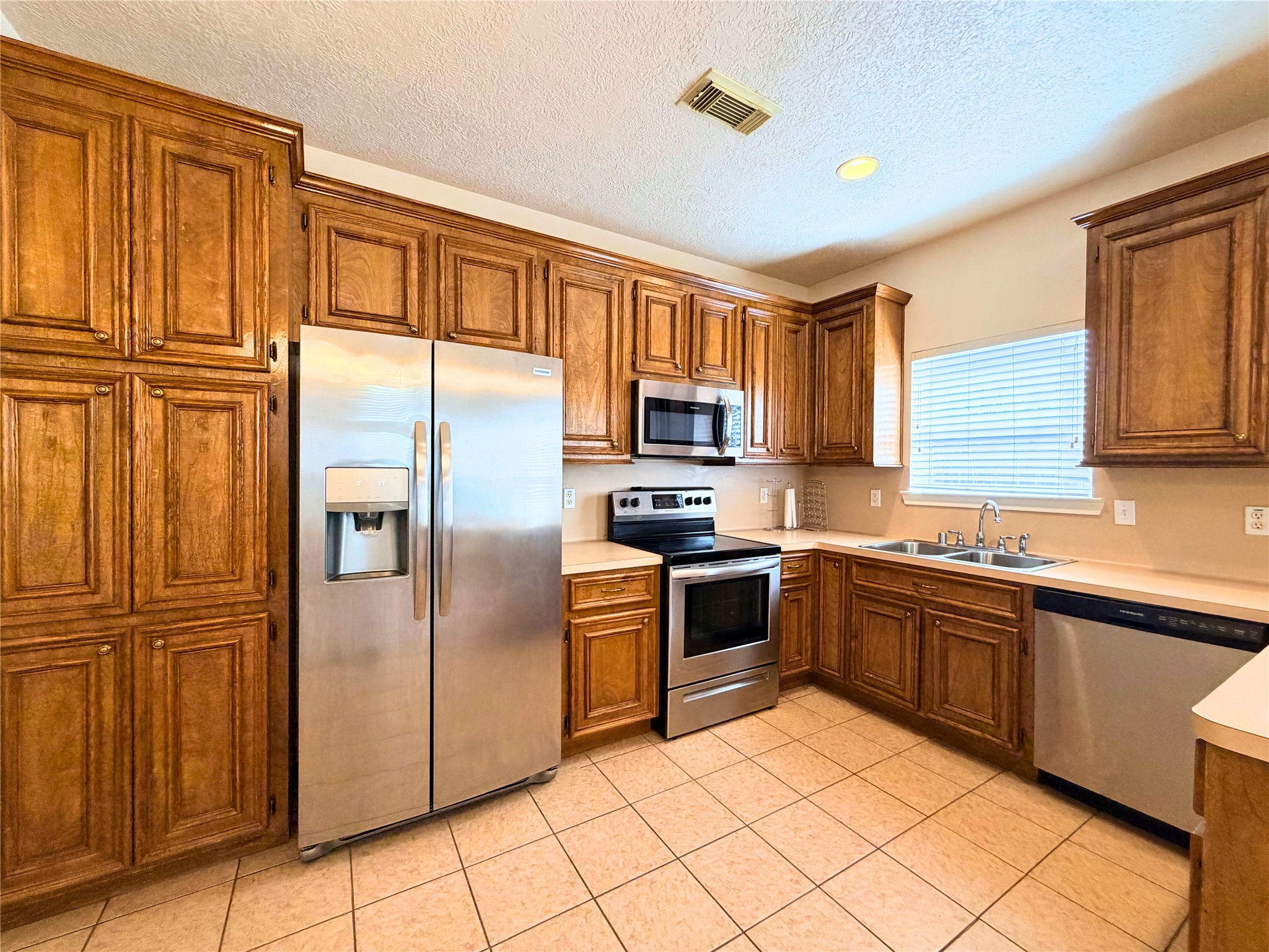 312 Hunt Road, Unit 312 Baytown, TX 77521 - Photo 14 of 28 a kitchen with stainless steel appliances granite countertop a refrigerator and a stove top oven