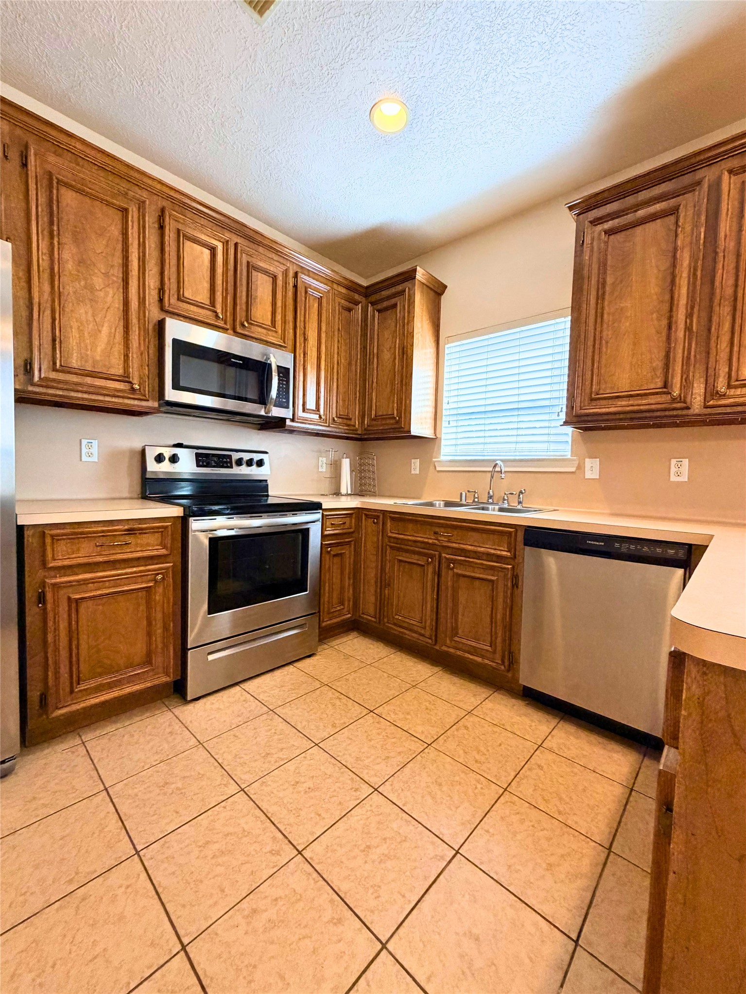 312 Hunt Road, Unit 312 Baytown, TX 77521 - Photo 15 of 28 a kitchen with stainless steel appliances granite countertop a stove top oven a sink dishwasher and white cabinets with wooden floor
