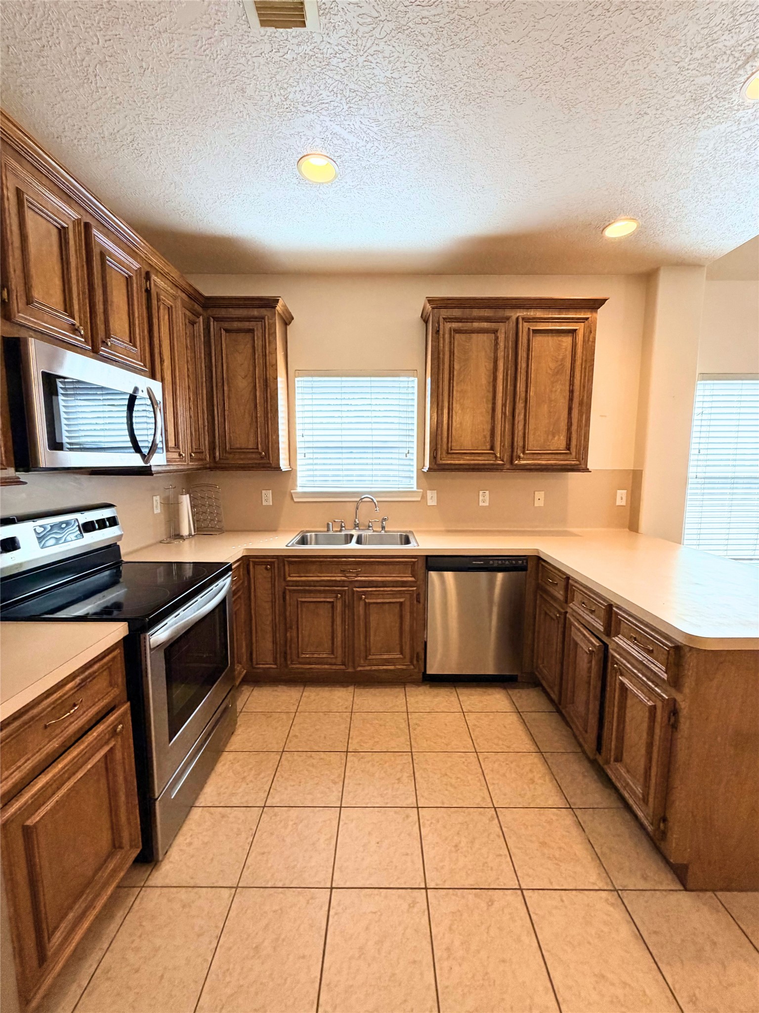 312 Hunt Road, Unit 312 Baytown, TX 77521 - Photo 16 of 28 a kitchen with stainless steel appliances a stove sink and cabinets